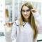 tiny-lady-dressed-up-white-sweater-holds-medical-glasses-her-arm-watch-trough-them-special-store-scaled-1-1.jpg